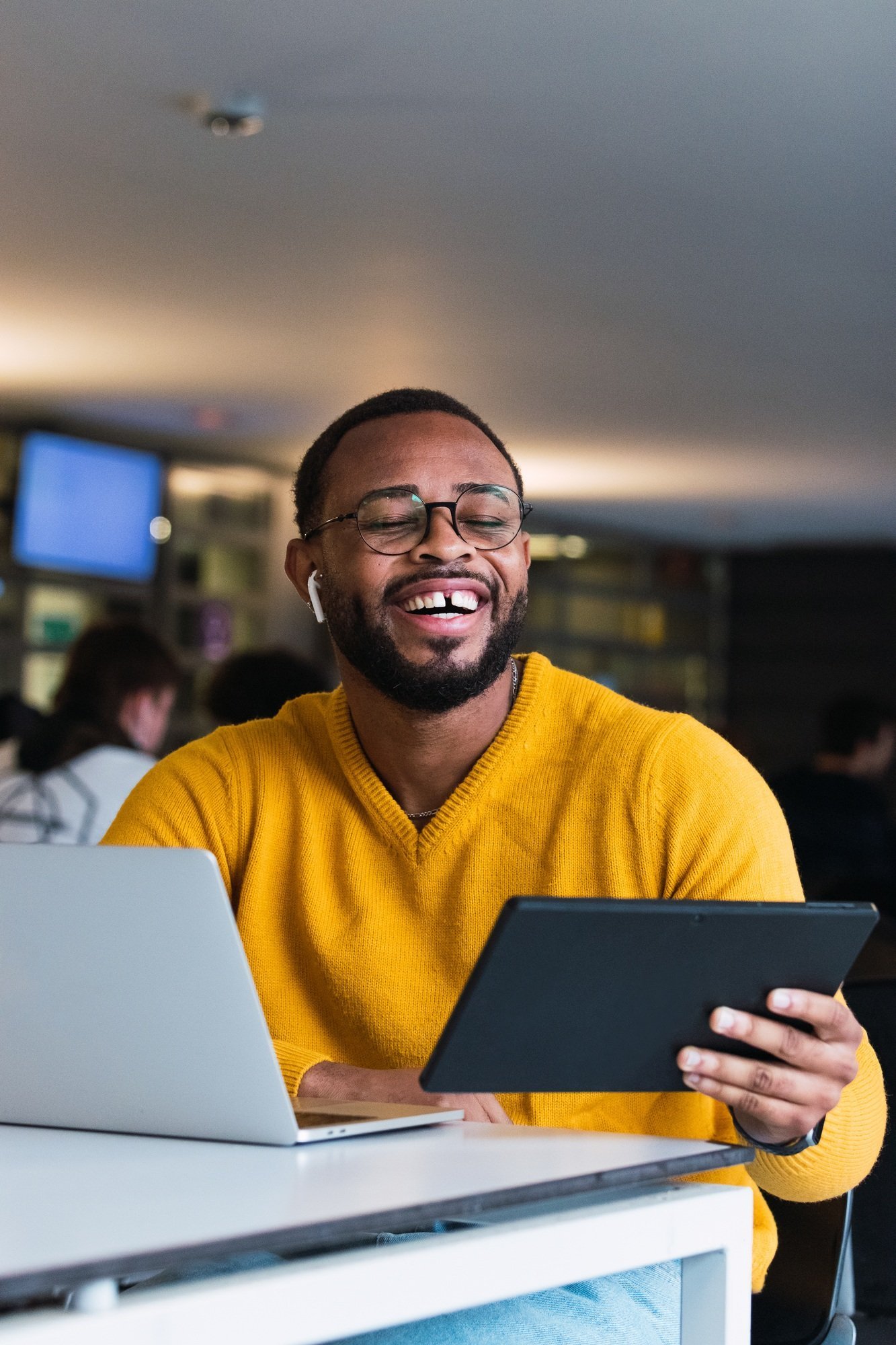 Smiling young founder working on a tablet at university