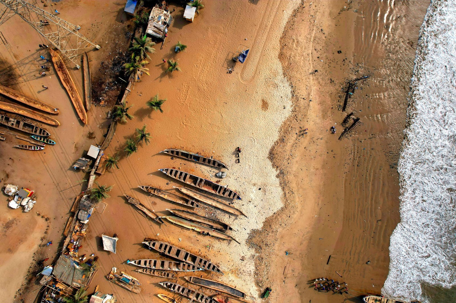 Aerial view of colourful wooden fishing boats on a beach in Tema, Ghana