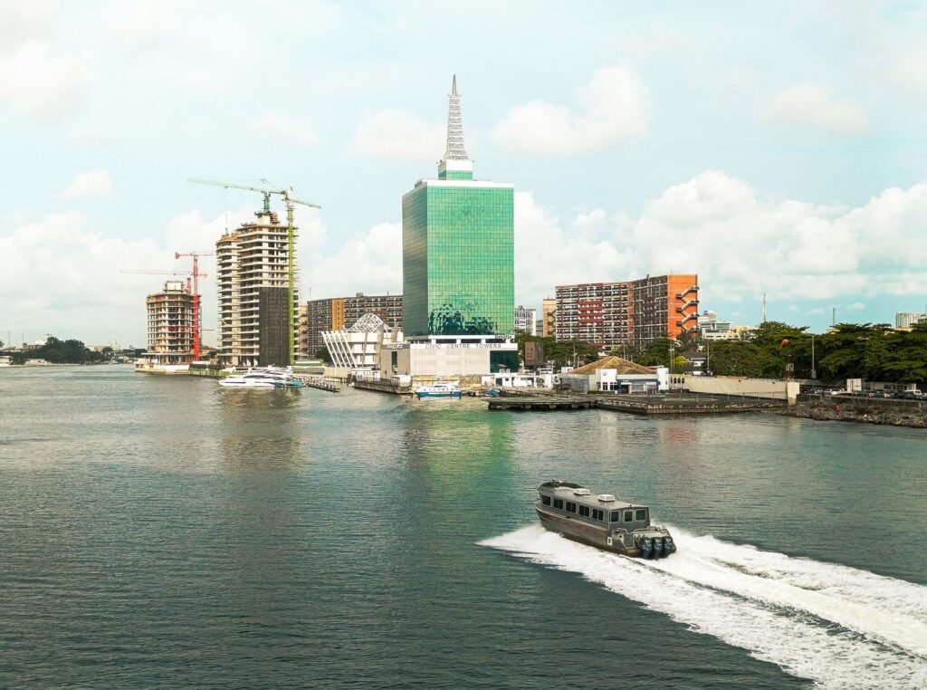 Lagos skyline with modern towers and a speedboat crossing the lagoon, Nigeria