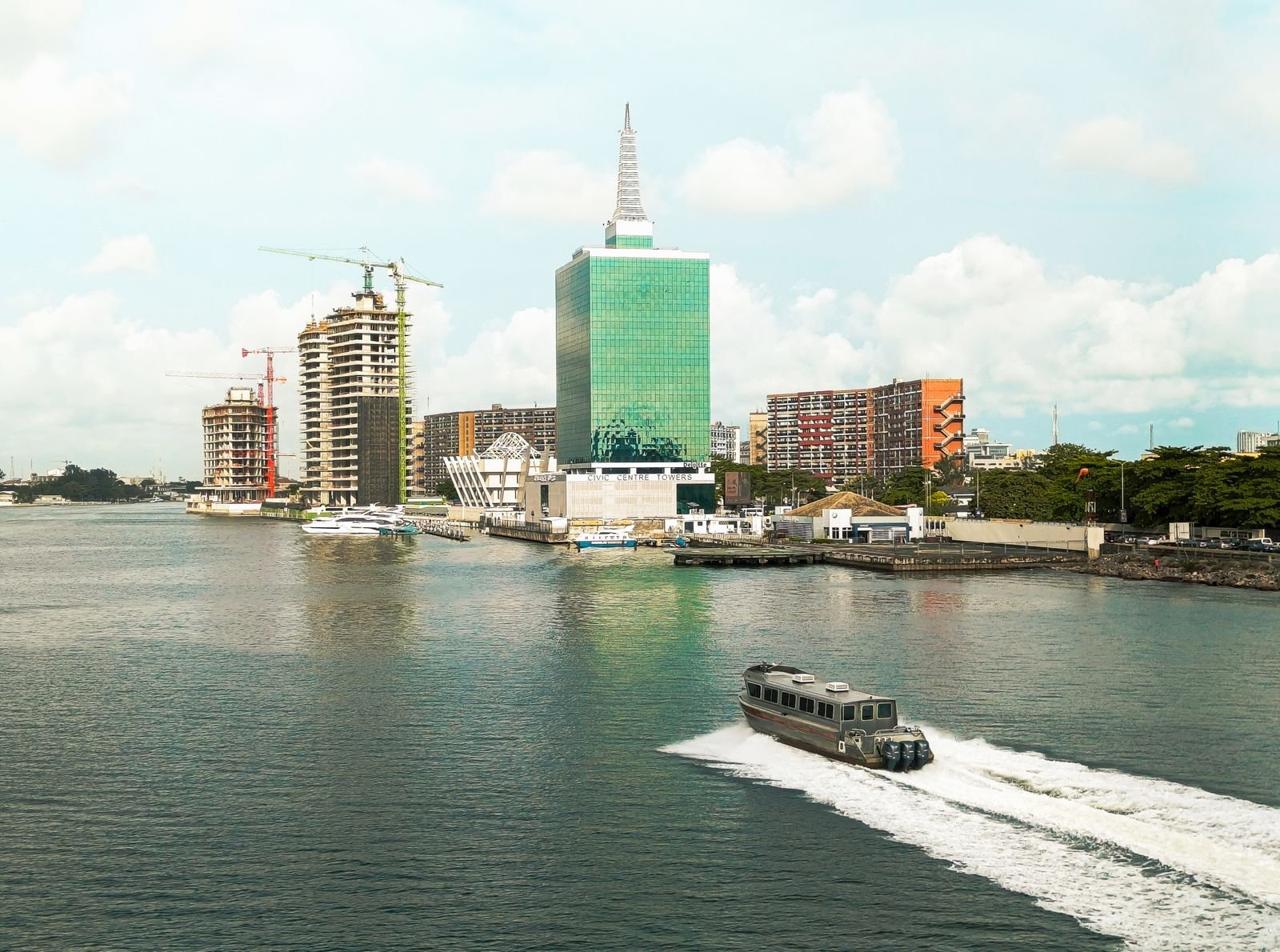 Lagos skyline with modern towers and a speedboat crossing the lagoon, Nigeria