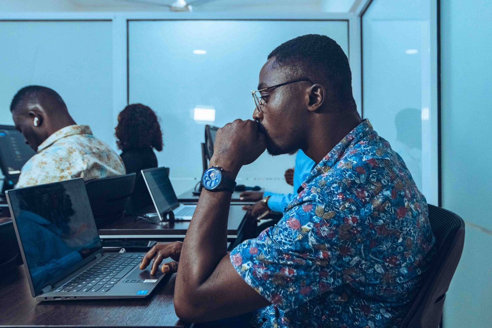 Young people coding on laptops in an IT workshop in Accra, Ghana