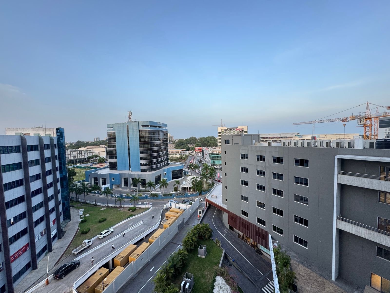 Modern office buildings and streets in Accra, Ghana, under a clear sky