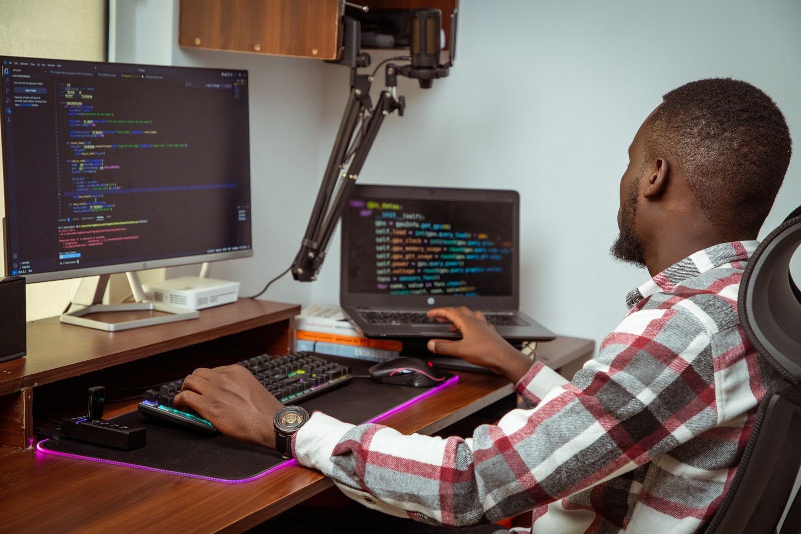 Developer writing code at a desk with two screens in a Nairobi office