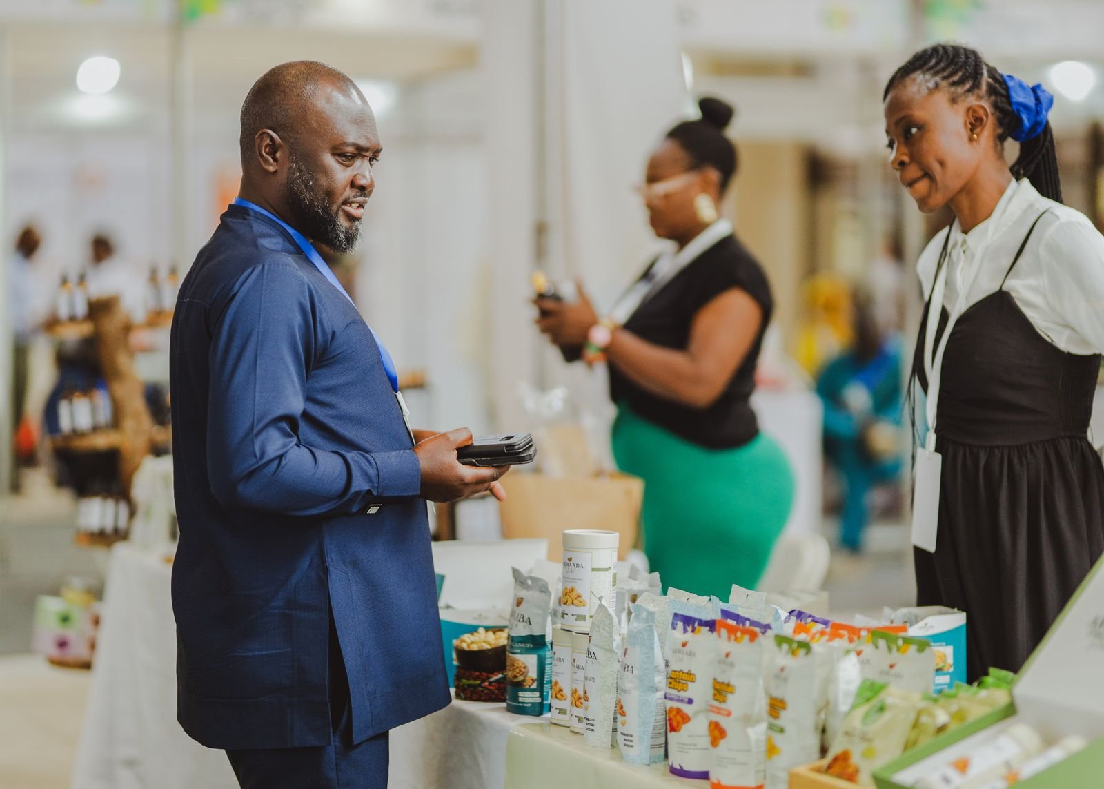 Business people talking at a trade show stand in Accra, Ghana