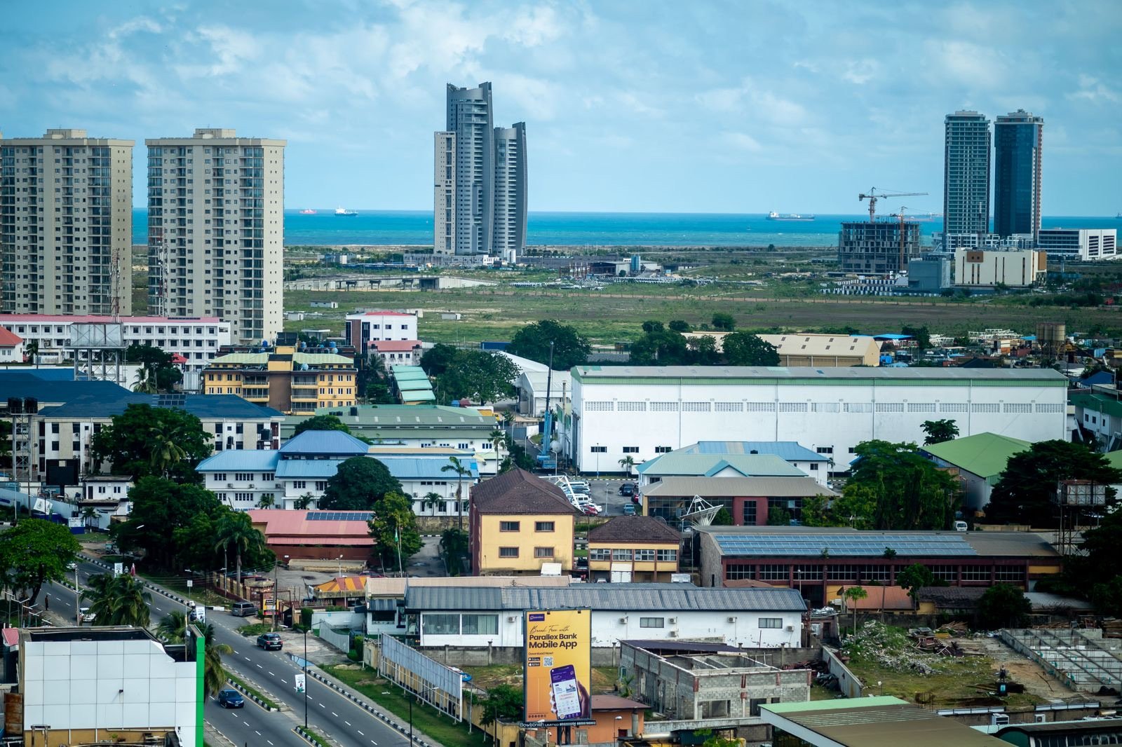 Aerial view of Lagos, Nigeria, with high-rise towers and the Atlantic Ocean behind