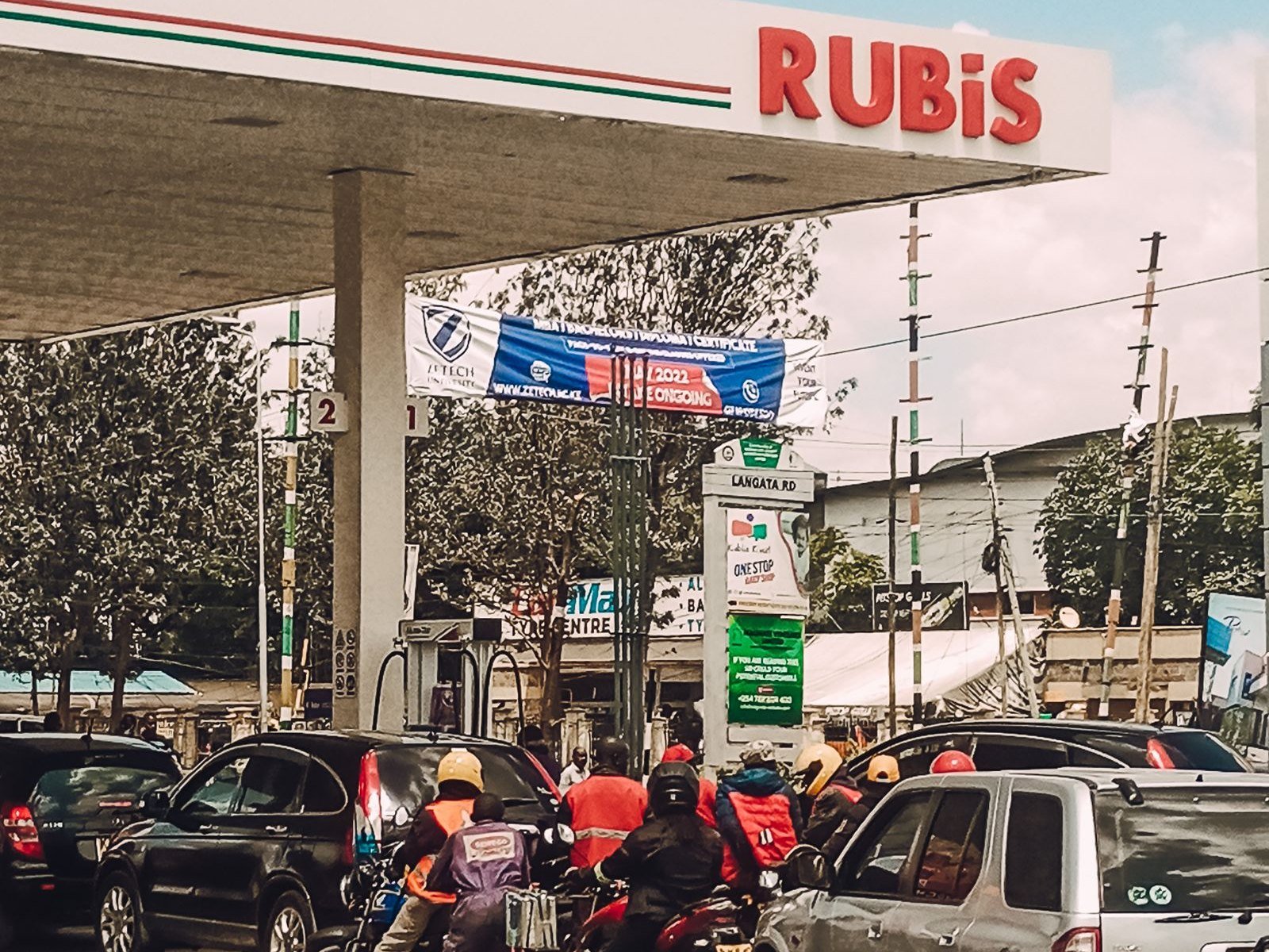 Boda boda riders and cars queueing for fuel at a Rubis petrol station on Langata Road, Nairobi
