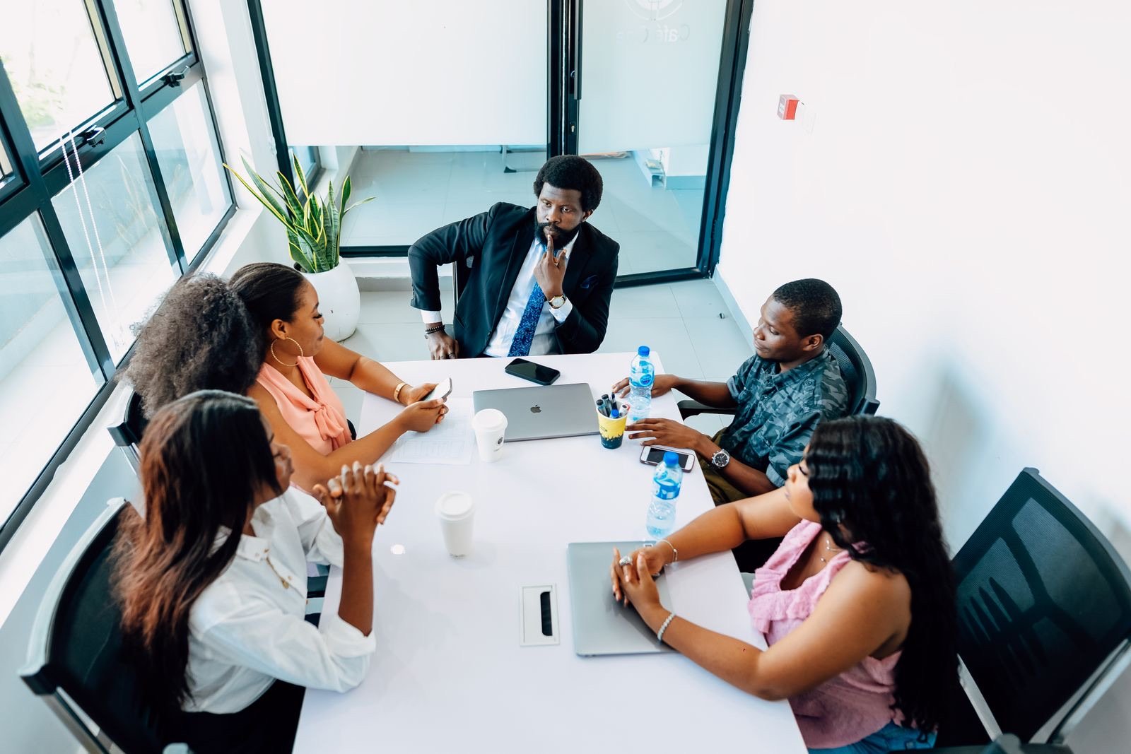 A group of founders and a mentor meeting around a table in a Lagos office